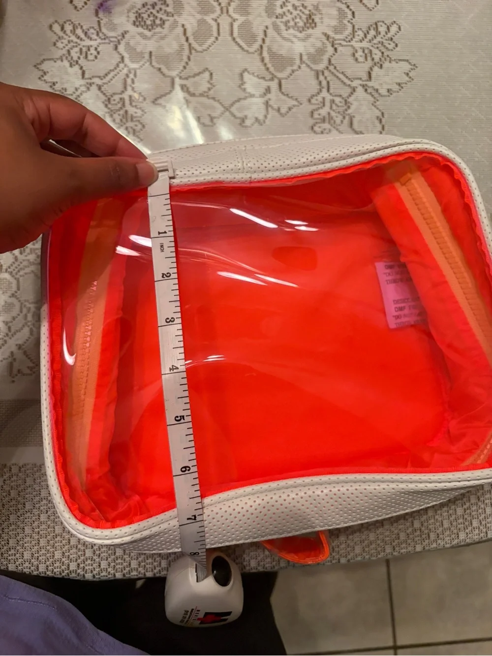 Drunk Elephant white and neon orange bag.